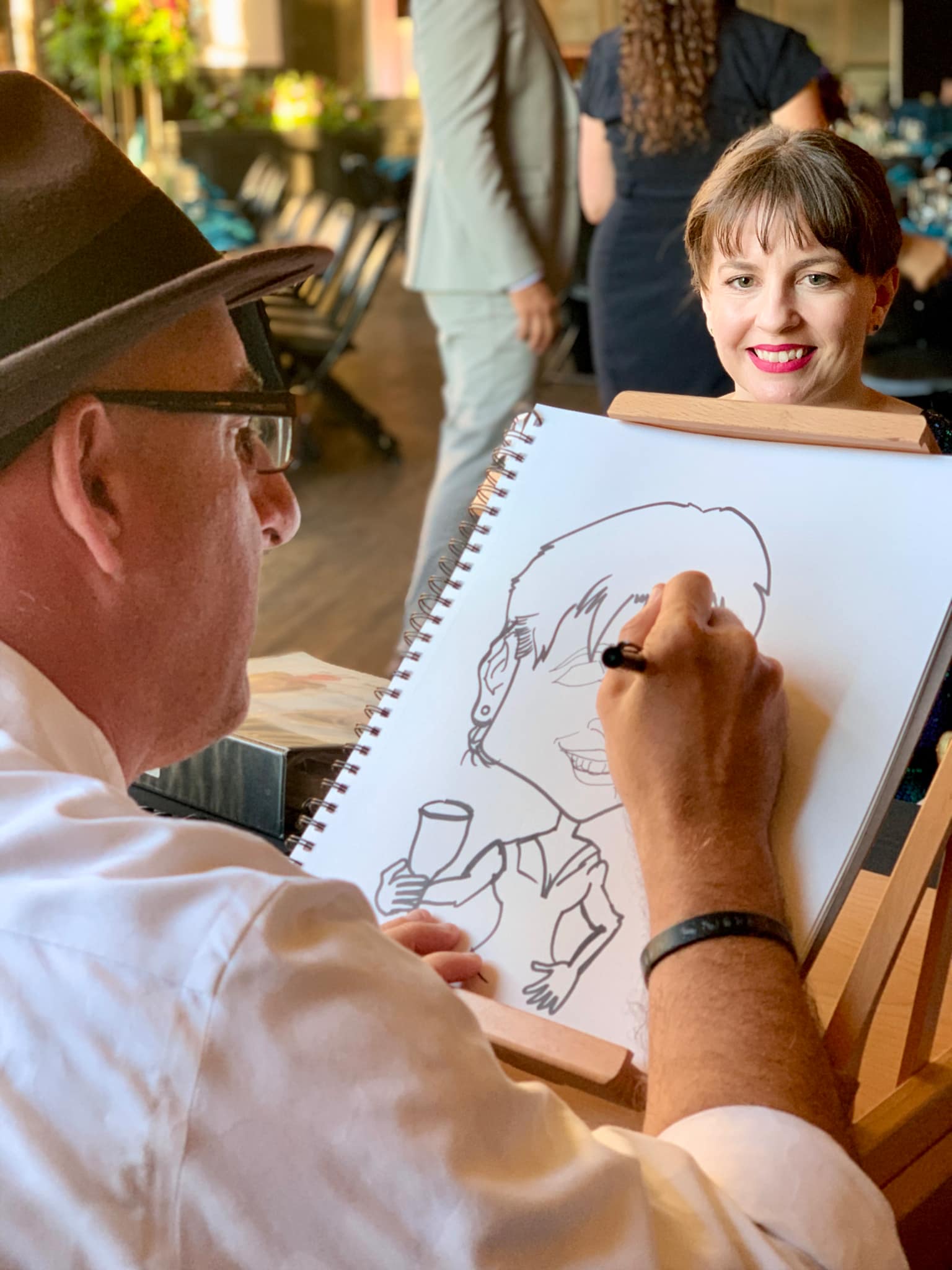 Timothy Baker drawing a caricature at an event